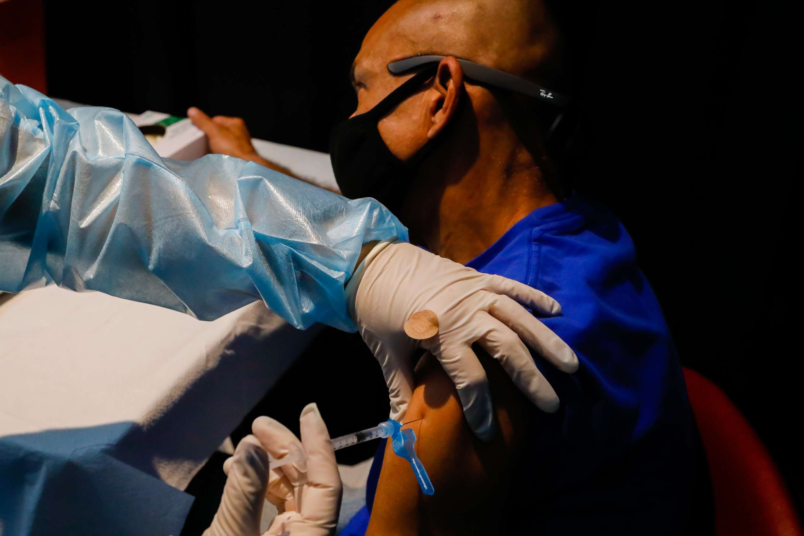 PHOTO: A healthcare worker administers a dose of a Covid-19 vaccine during an event hosted by the Miami Heat at the FTX Arena in Miami,  Aug. 5, 2021.