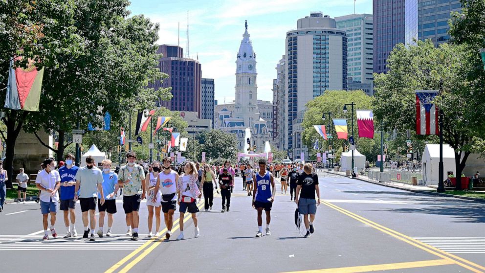 PHOTO: Fans walk in front of City Hall as they arrive at the Made In America festival in Philadelphia, Sept. 4, 2021.