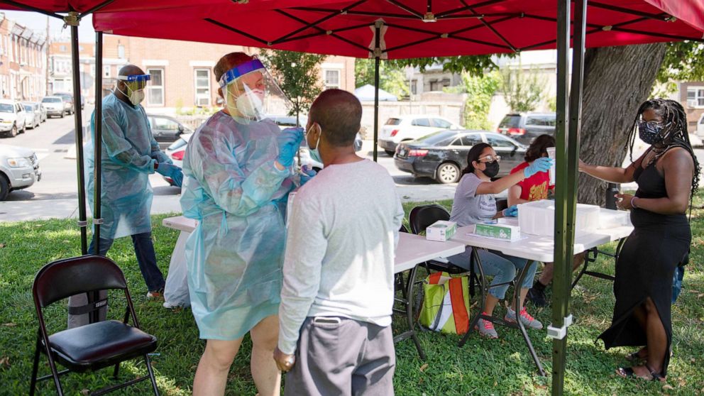 PHOTO: A healthcare worker administers a Covid-19 test at a testing site in Mifflin Square Park in Philadelphia, Aug. 12, 2021.