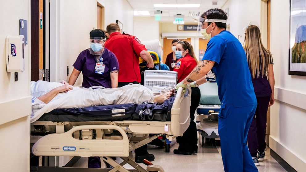 PHOTO: Emergency Room nurses and EMTs tend to patients in hallways at the Houston Methodist The Woodlands Hospital in Houston, Aug. 18, 2021. 