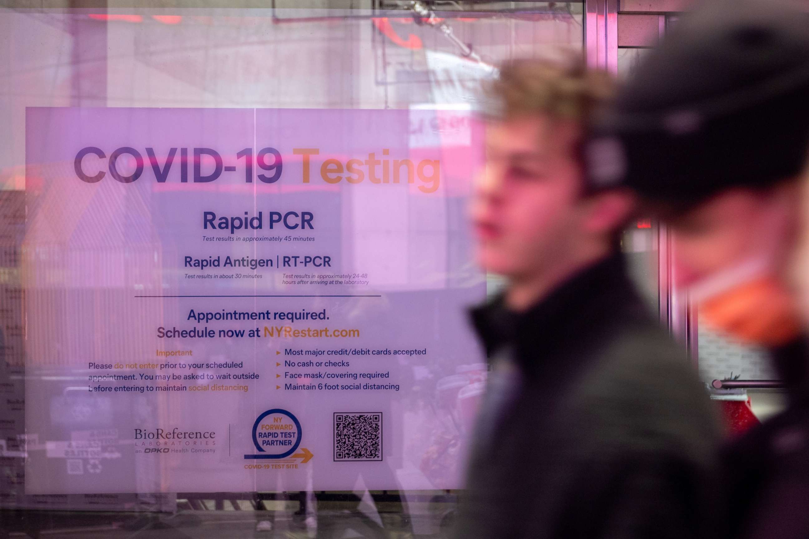 PHOTO: Tourists walk past a COVID-19 testing location in Times Square in New York, Nov. 27, 2021.