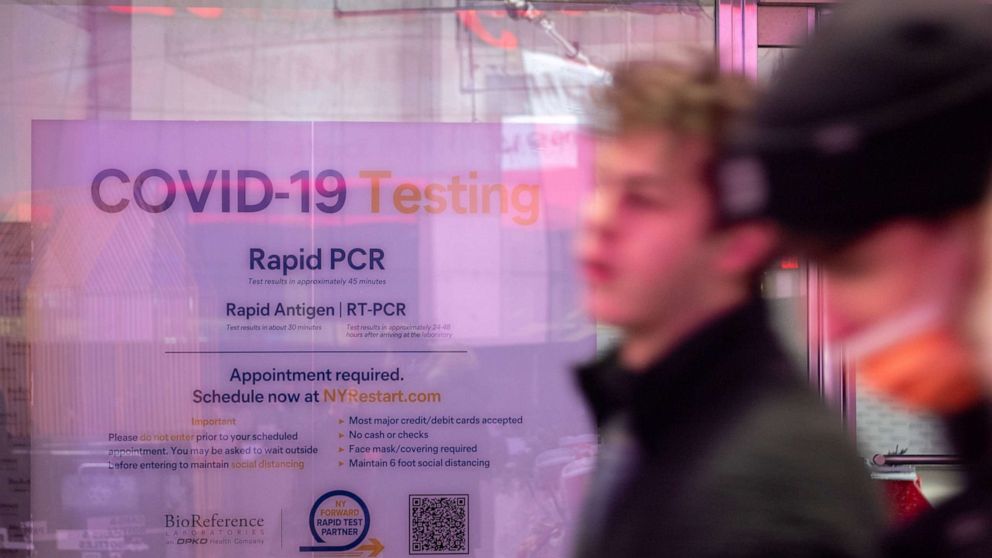 PHOTO: Tourists walk past a COVID-19 testing location in Times Square in New York, Nov. 27, 2021.