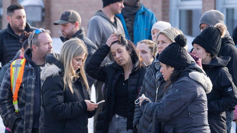 PHOTO: Parents wait for news after a bus crashed into a daycare centre in Laval, Quebec, Feb. 8, 2023.