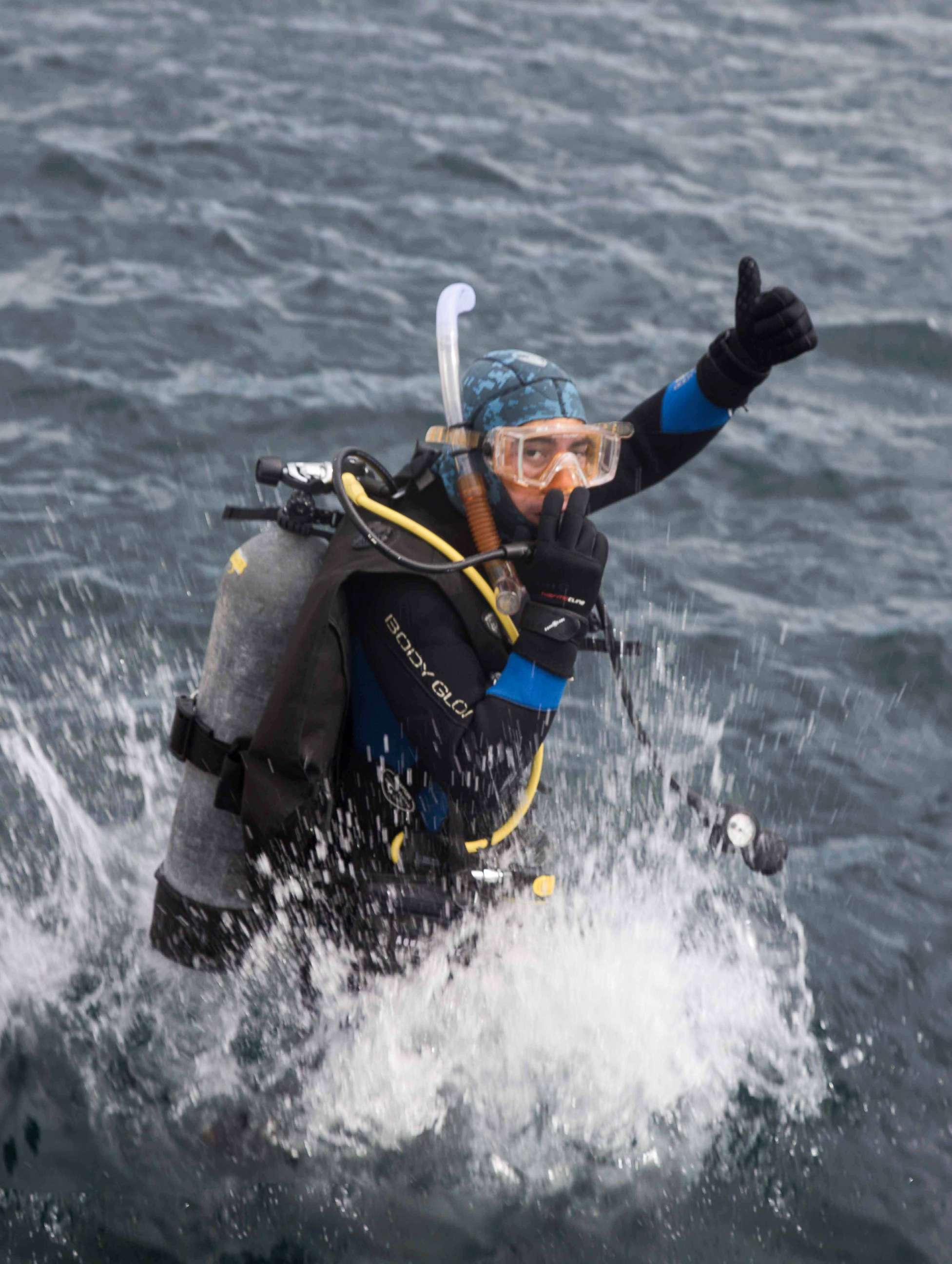 PHOTO: A Dive Warrior participant gives a thumbs up while jumping in the water off the California coast.