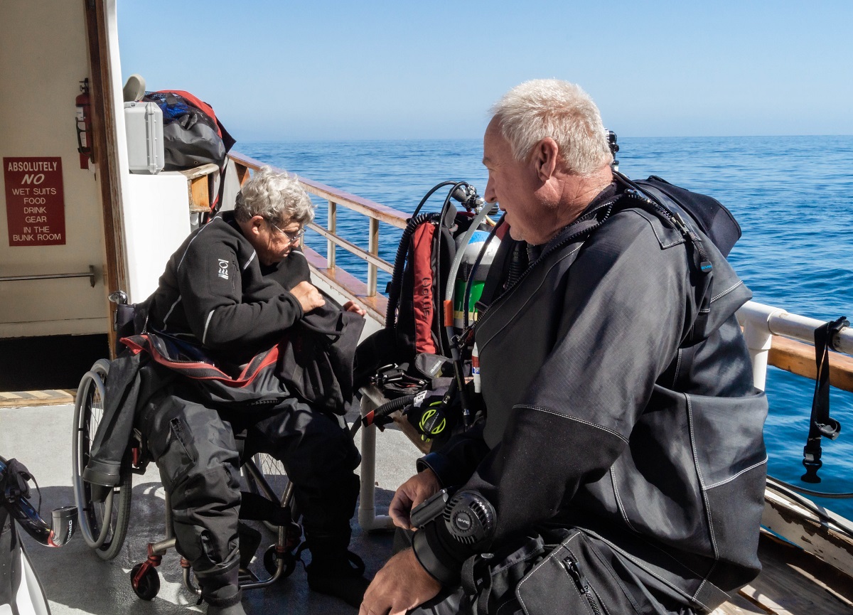 PHOTO: Dive Warriors Divemaster Kelly McCumiskey gears up before jumping into the ocean.
