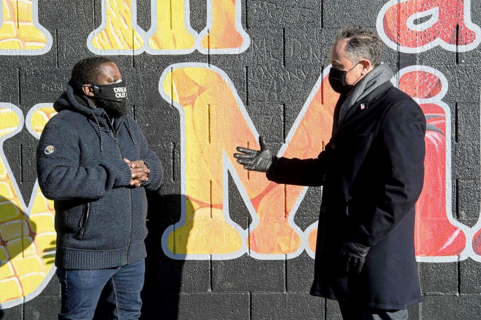 PHOTO: Second Gentleman Doug Emhoff speaks with Christopher Bradshaw during a visit to the farm at Kelly Miller middle school, Washington, Jan. 28, 2021. 