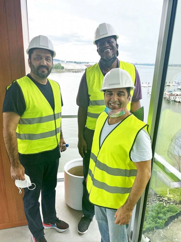 PHOTO: Developer Mustafa Durrani (far left) is joined by two friends, at a project in which they've invested. 