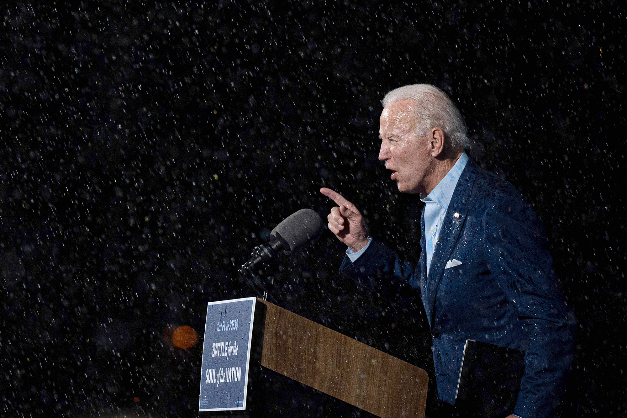 PHOTO: Former vice-president and Democratic presidential nominee Joe Biden delivers remarks in the rain during a Drive-In event in Tampa, Fla., Oct. 29, 2020.