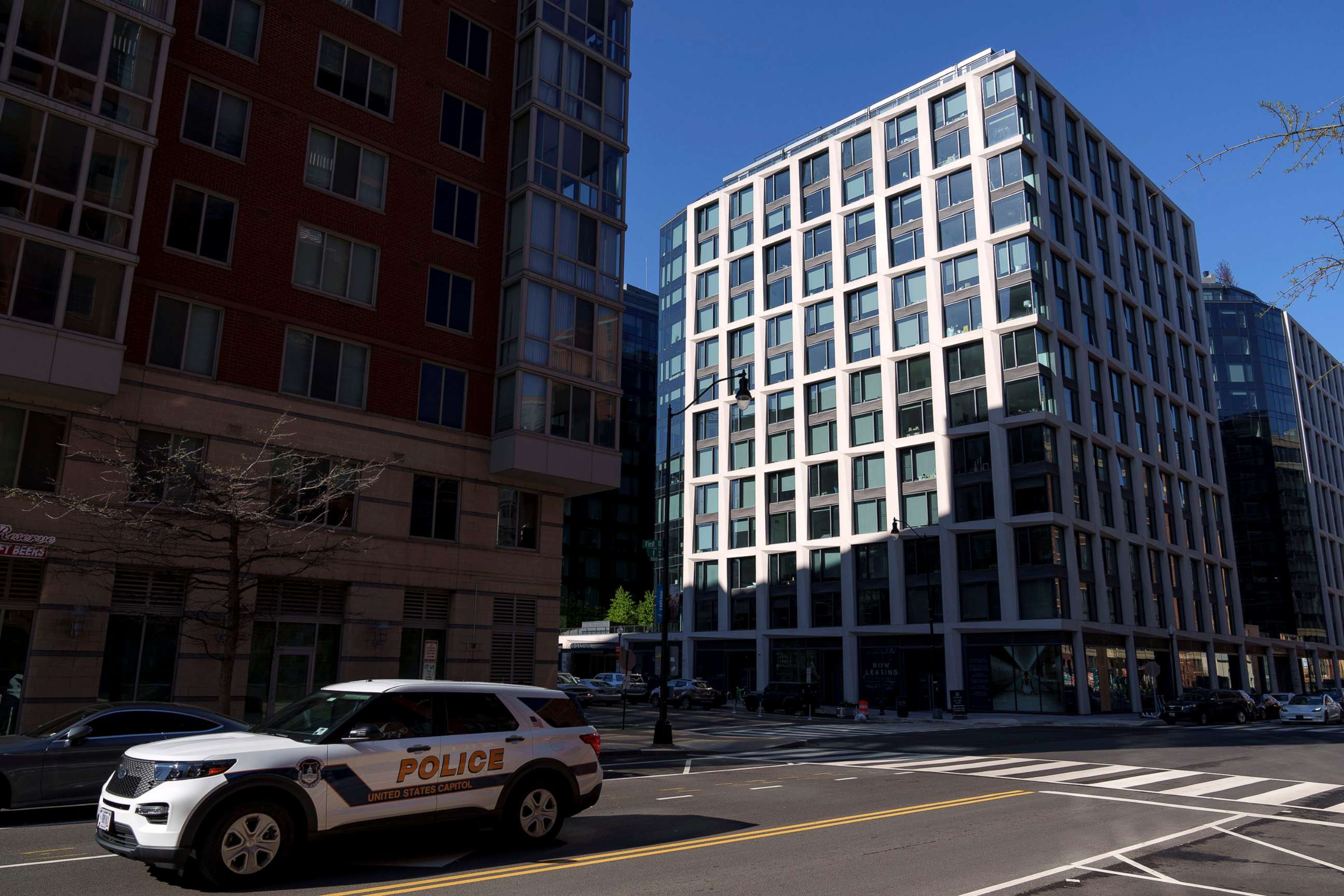 PHOTO: A Capitol Police vehicle drives past The Crossing apartment building on April 8, 2022 in Washington, D.C. The building, which was raided by the FBI on April 6, is the home of two men accused of posing as federal law enforcement employees.