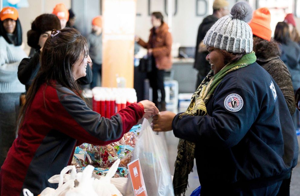 PHOTO: Amelia Williams, right, a furloughed employee of the TSA, collects goods at a food donation site set up for federal workers by the Food Bank of NYC at the Barclays Center in Brooklyn, New York, Jan. 22, 2019.