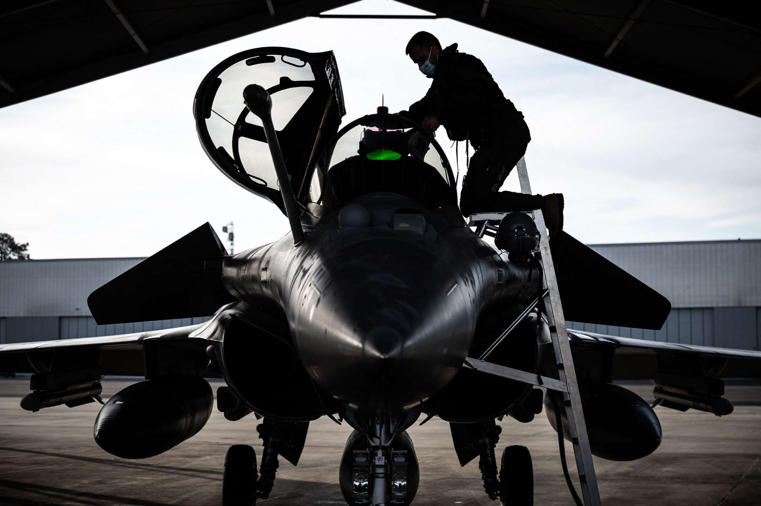 PHOTO: A Rafale fighter jet pilot inspects his aircraft prior to taking off for a daily NATO border watch mission sortie over Poland at the Mont-de-Marsan airbase, southwestern France, March 1, 2022.