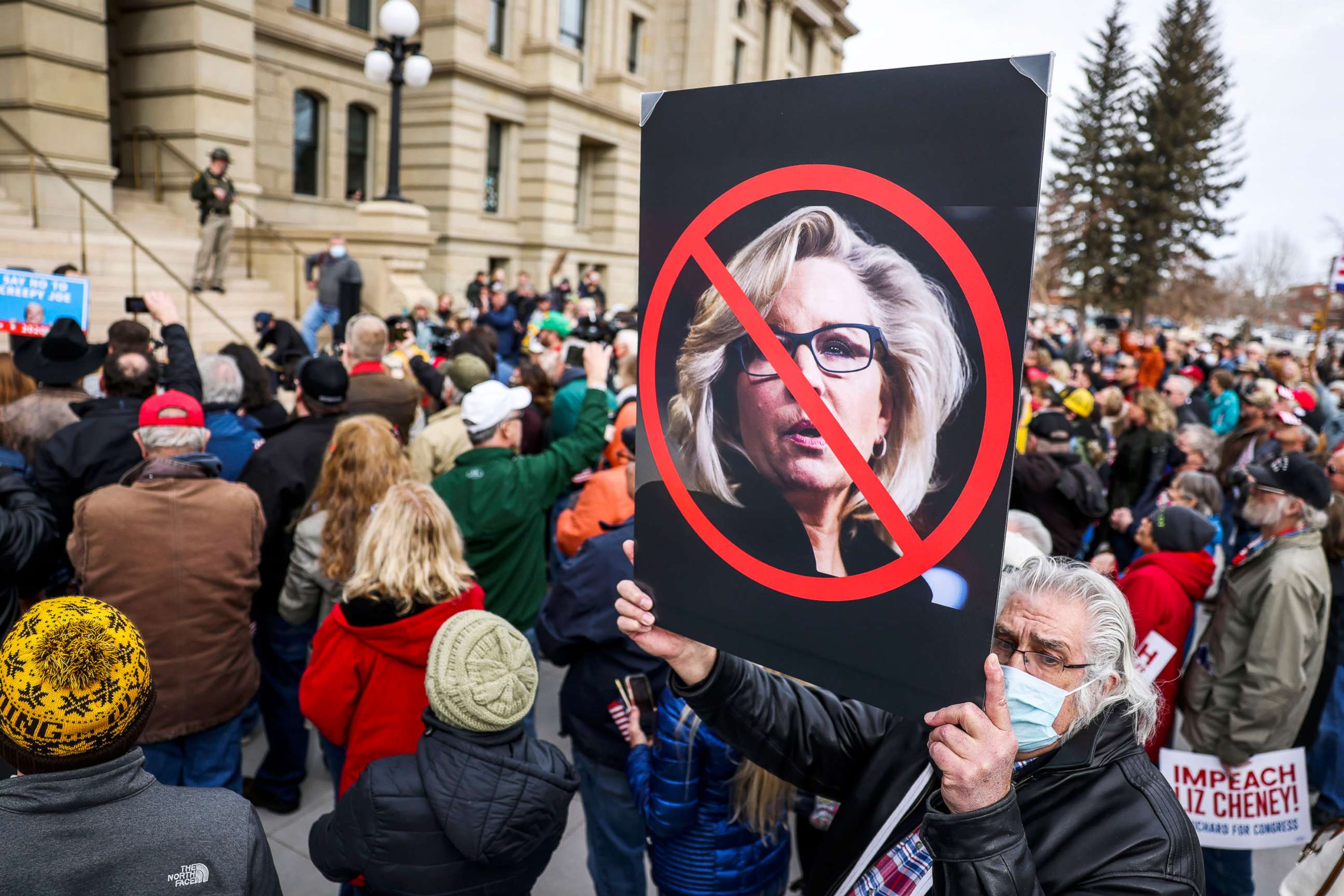 PHOTO: A sign against Rep. Liz Cheney is held up in the crowd as Rep. Matt Gaetz speaks during a rally against her in Cheyenne, Wyo., Jan. 28, 2021.
