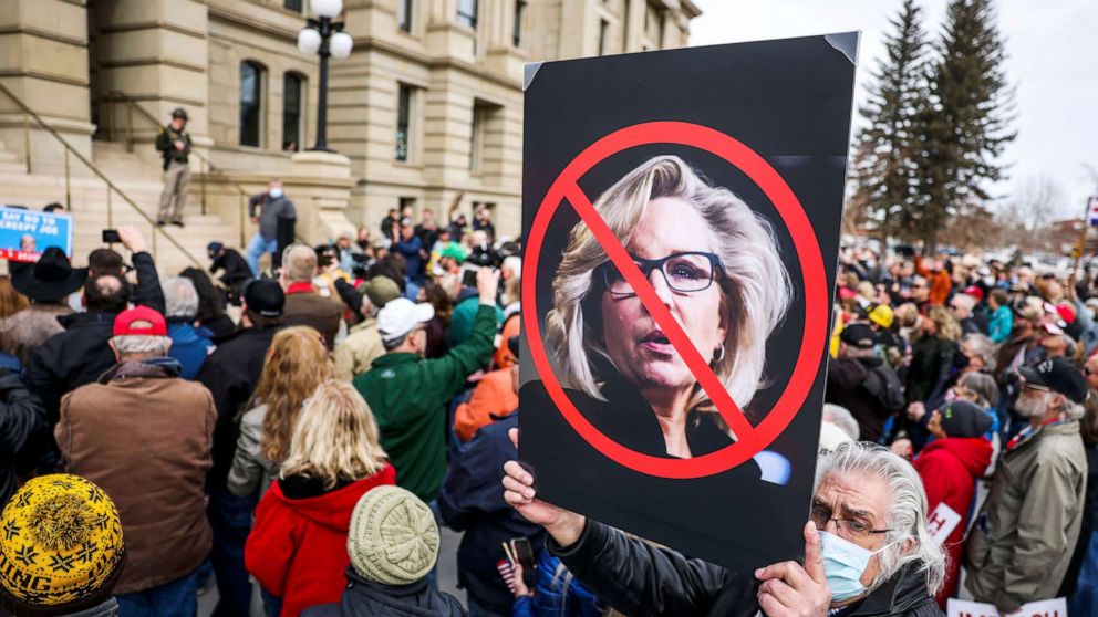 PHOTO: A sign against Rep. Liz Cheney is held up in the crowd as Rep. Matt Gaetz speaks during a rally against her in Cheyenne, Wyo., Jan. 28, 2021.