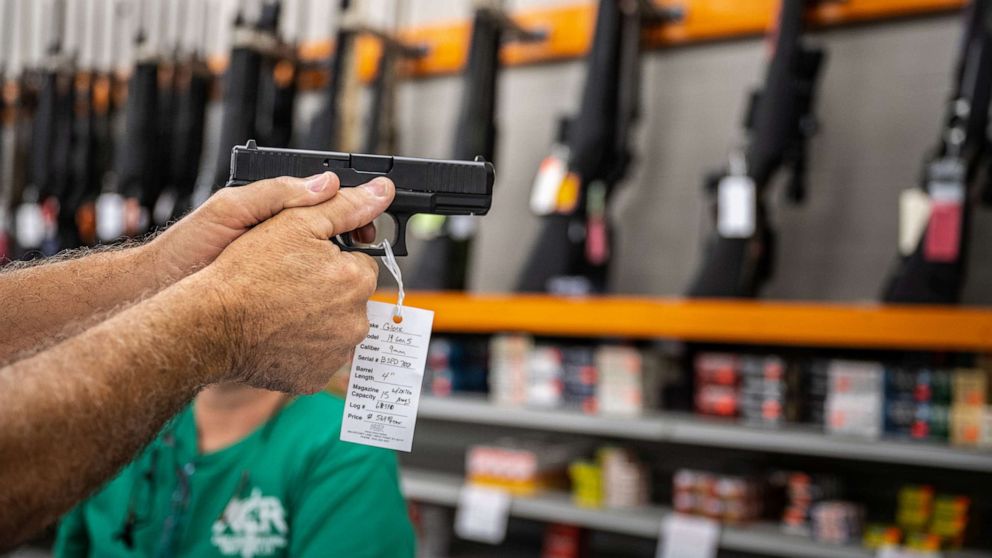 PHOTO: A customer holds a handgun for sale at Knob Creek Gun Range in West Point, Ky., July 22, 2021.