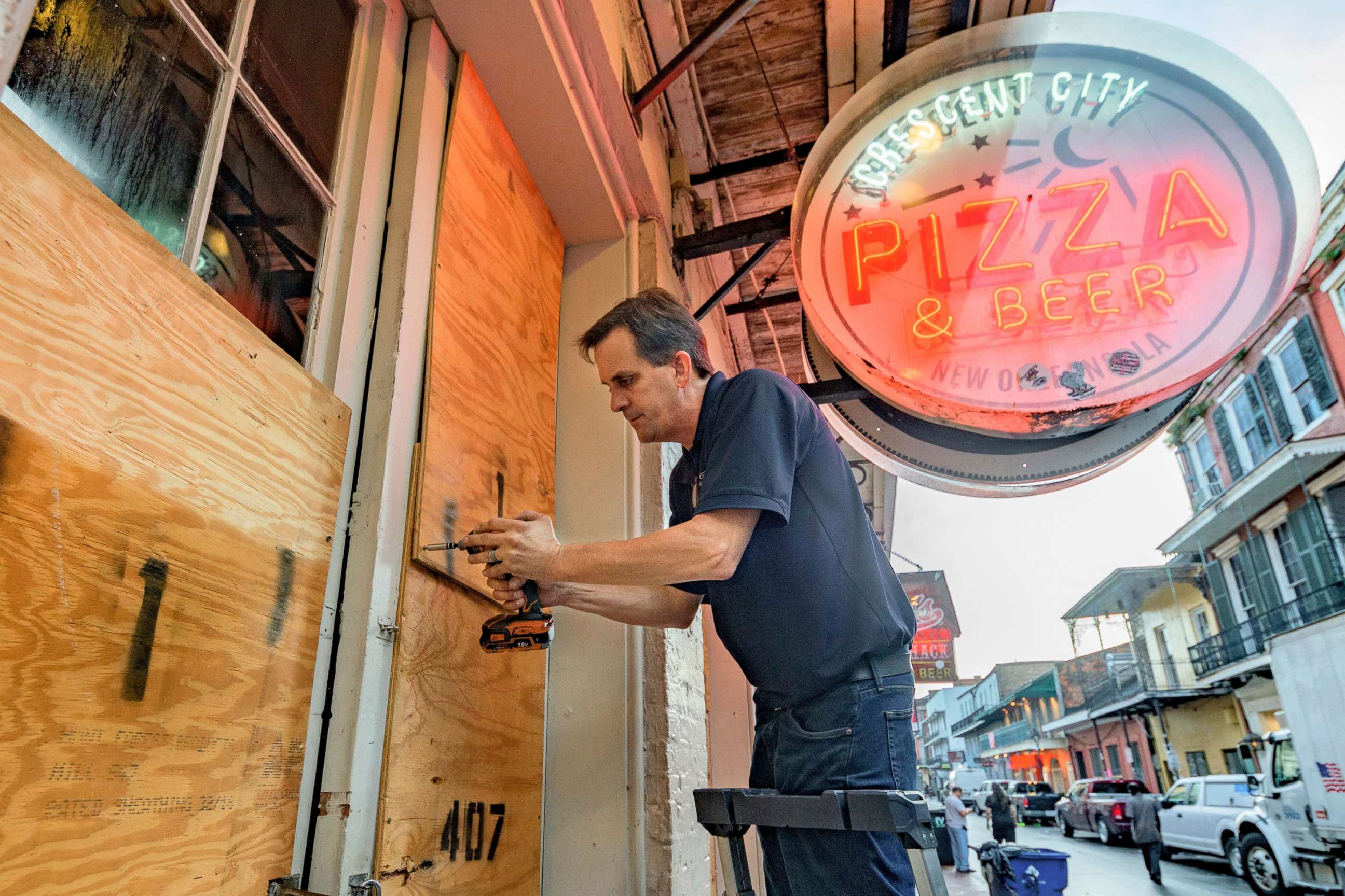 PHOTO: Michael Richard boards up Crescent City Pizza on Bourbon Street in the French Quarter before landfall of Hurricane Ida in New Orleans, Aug. 28, 2021.