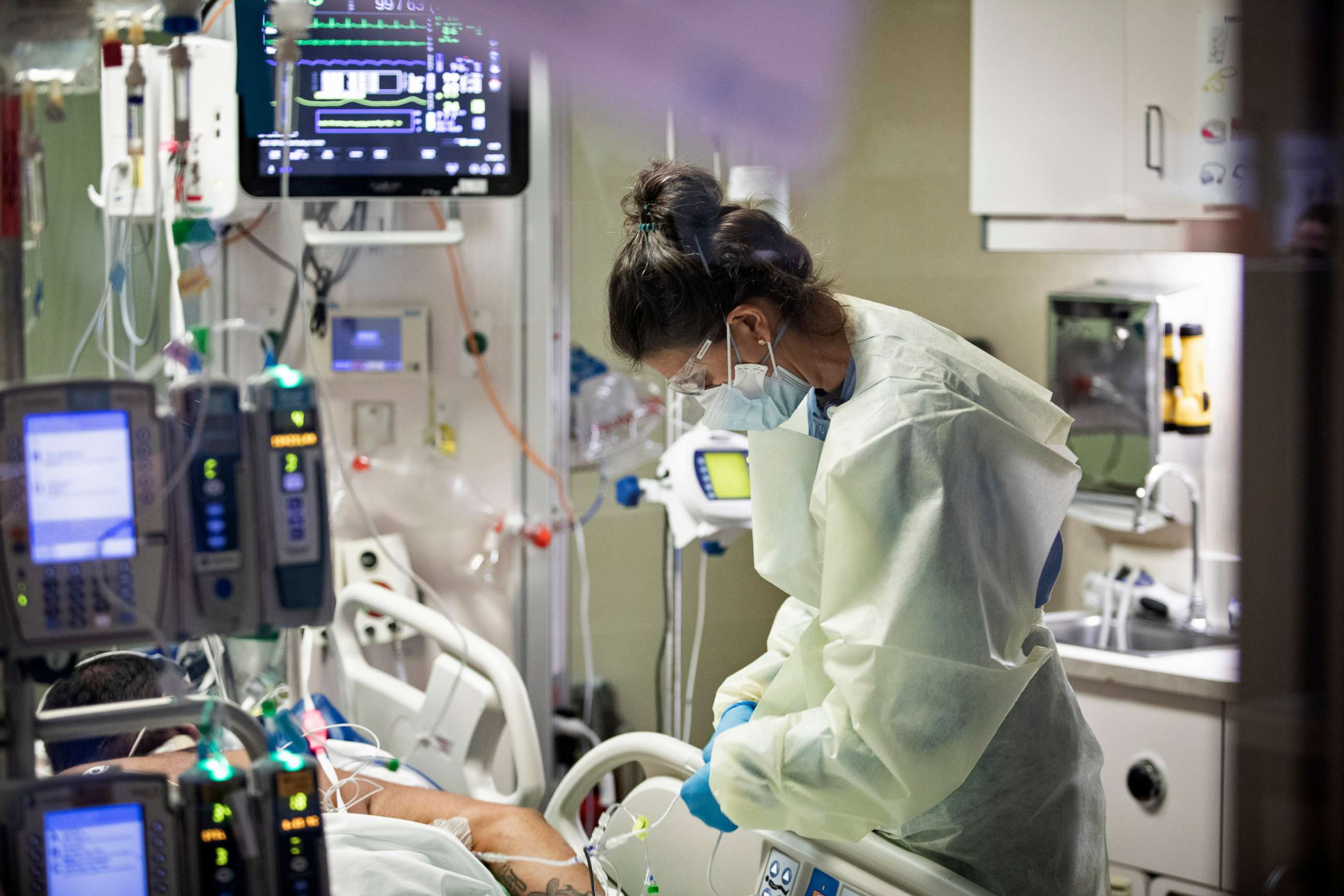 PHOTO: Registered nurse Ann Enderle checks on a COVID-19 patient in the Medical Intensive care unit at St. Luke's Boise Medical Center in Boise, Idaho on Aug. 31, 2021.