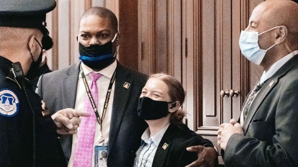 PHOTO: Capitol Police Officer Eugene Goodman speaks with fellow officers during the second day of the impeachment trial of former President Donald Trump in Washington,Feb. 10, 2021.