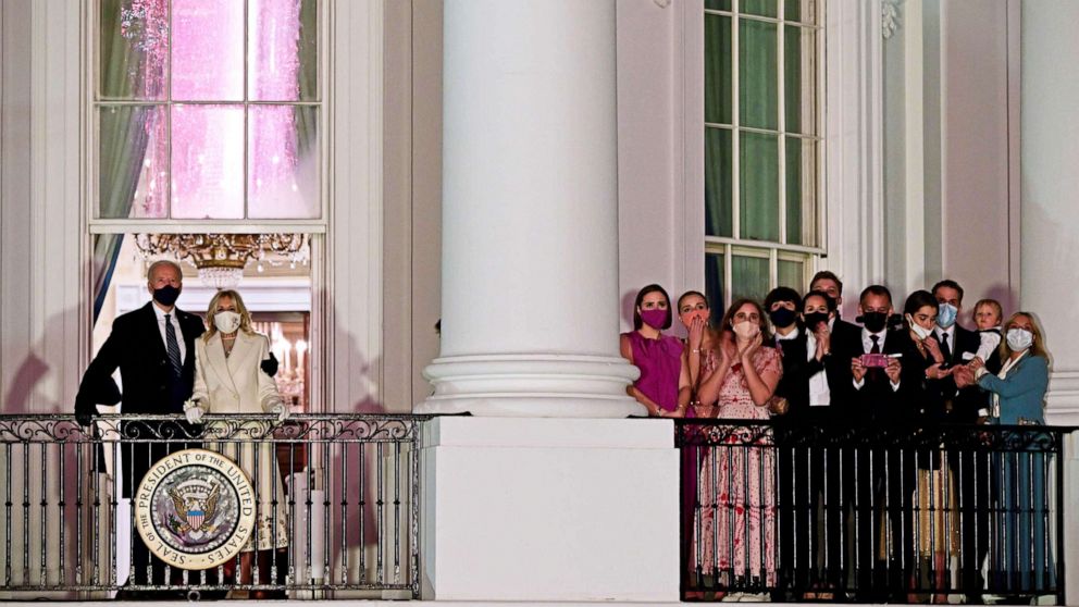 PHOTO: President Joe Biden  and First Lady Jill Biden appear on the Blue Room Balcony as they and family members watch fireworks from the White House in Washington, Jan. 20, 2021. 