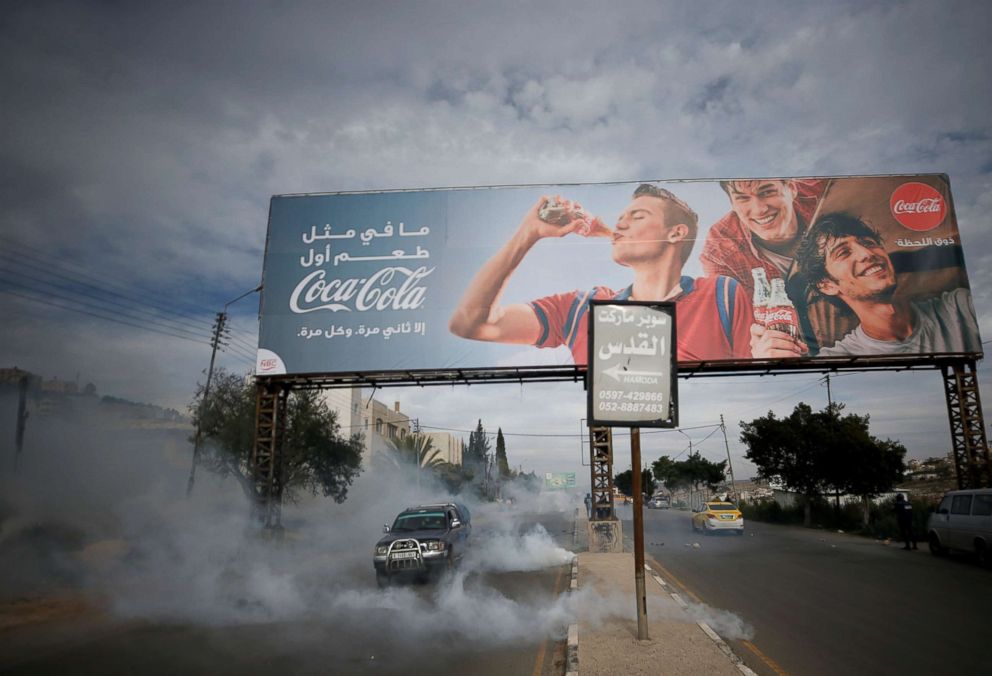 PHOTO: Tear gas canisters are fired by Israeli troops towards Palestinians during clashes at the Hawara checkpoint near Nablus in the occupied West Bank, Dec. 2, 2018.