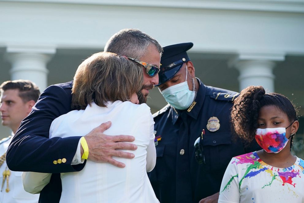 PHOTO: House Speaker Nancy Pelosi hugs Washington Metropolitan Police Department officer Michael Fanone before President Joe Biden signs a bill in the Rose Garden of the White House, in Washington, Aug. 5, 2021.