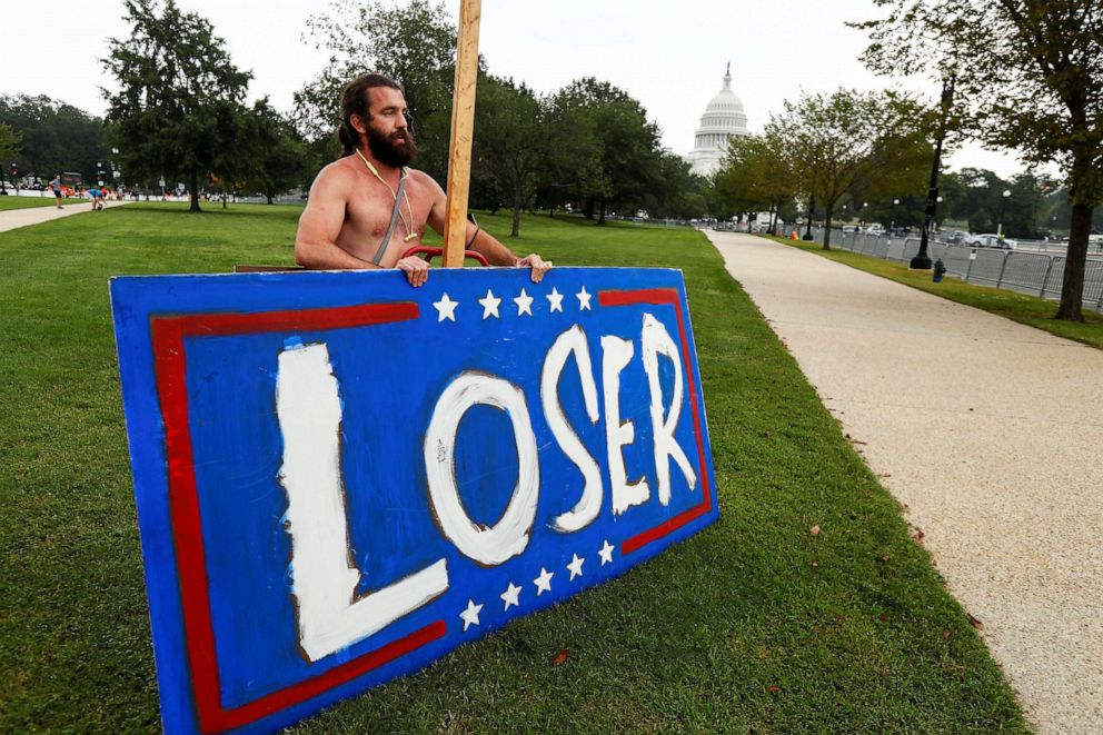 PHOTO: Counter-protester Tim Smith sets up a sign he said refers to former U.S. President Donald Trump near the Capitol in Washington, Sept. 18, 2021. 