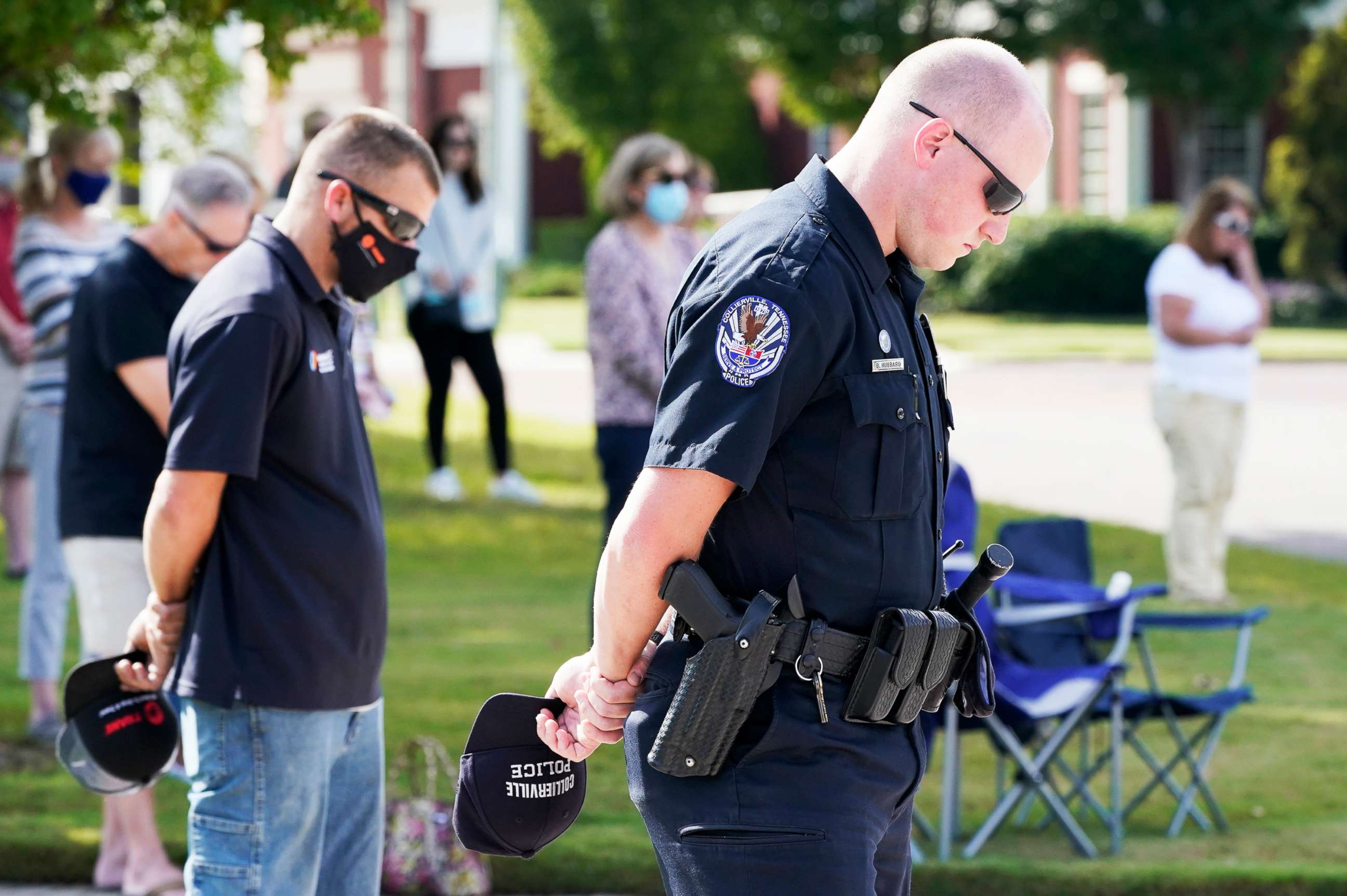 PHOTO: Officer Ben Hubbard, of the Collierville Police Department, and other residents pray during a vigil at Town Hall, Collierville, Tenn., Sept. 24, 2021.