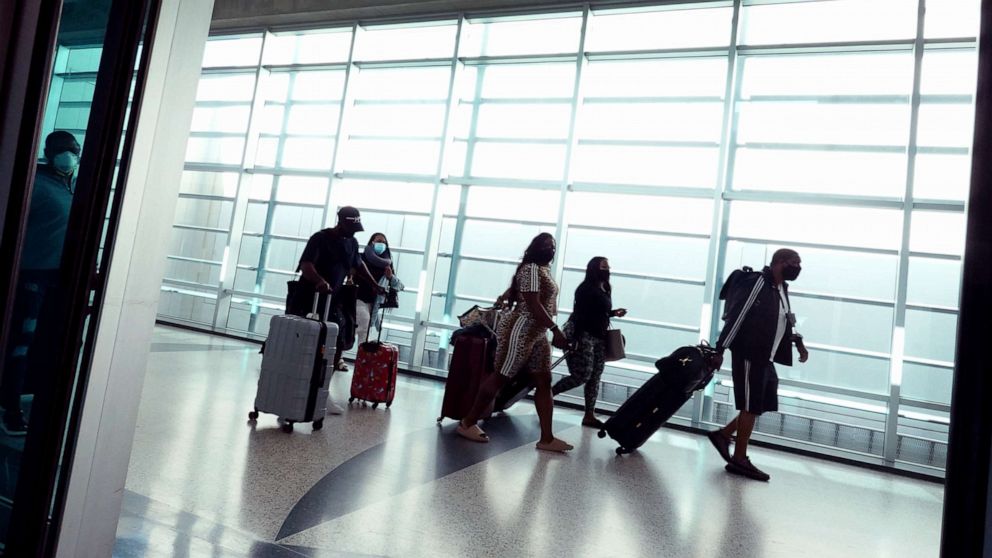 PHOTO: Travelers make their way through the Miami International Airport before starting the Labor Day weekend in Miami, Sept. 03, 2021.