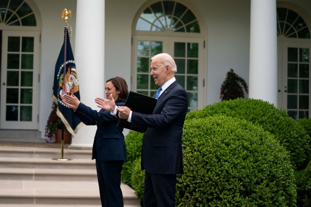PHOTO: Vice President Kamala Harris and President Joe Biden greet their staff after speaking on updated guidance on mask mandates, in the Rose Garden of the White House, May 13, 2021.
