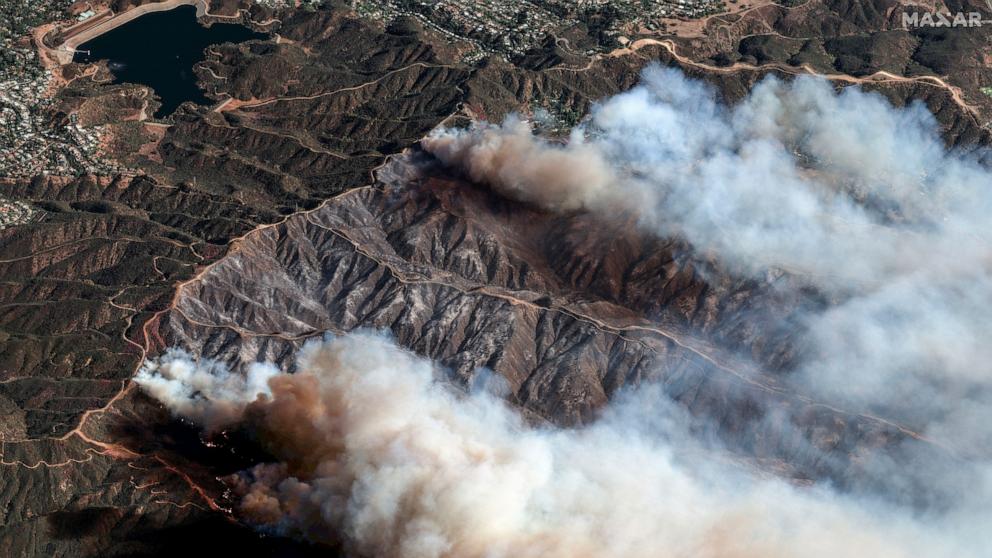PHOTO: In this photo provide by Maxar Technologies, the Palisades Fire burns south of the Encino Reservoir, upper left, in Los Angeles, Jan. 11, 2025.