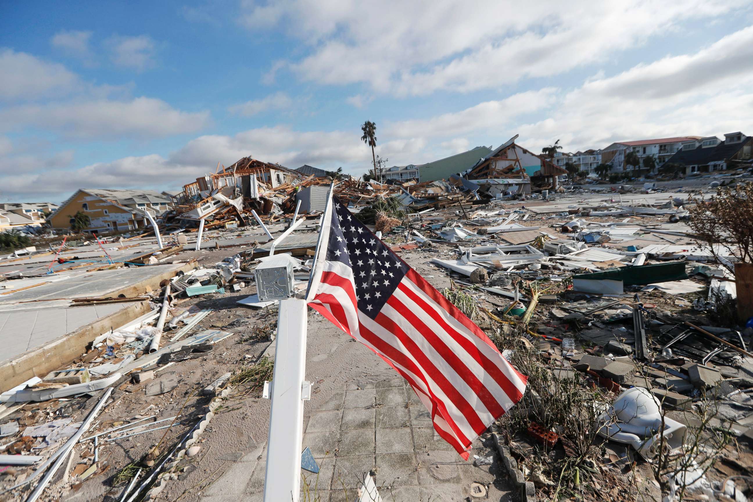 PHOTO: An American flag flies amidst destruction in the aftermath of Hurricane Michael in Mexico Beach, Fla., Oct. 11, 2018.