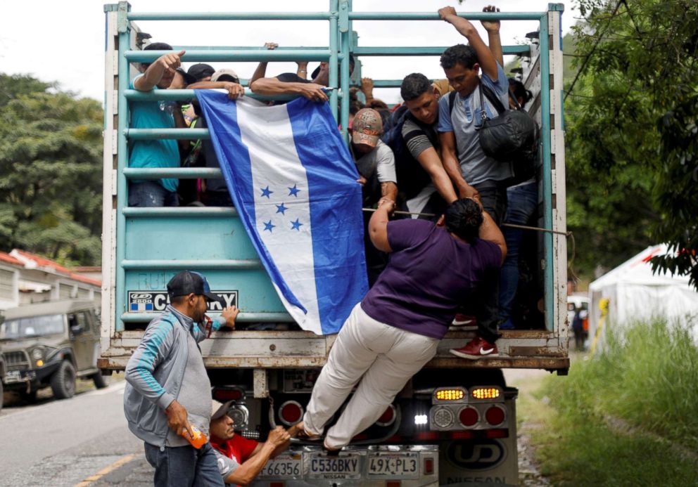 PHOTO: A Honduran migrant, part of a caravan trying to reach the U.S., climbs on a truck in Quezaltepeque, Guatemala, Oct. 16, 2018.