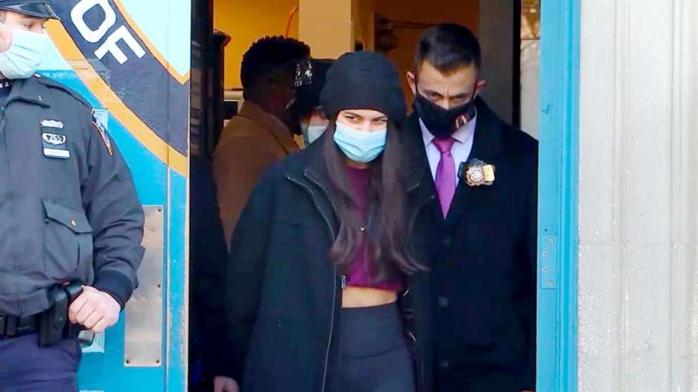 PHOTO: Miya Ponsetto, 22, is walked from a precinct in New York City as she faces multiple charges for a Manhattan hotel incident during which she is seen on video  seen on video tackling a Black teenager whom she falsely accused of stealing her phone.