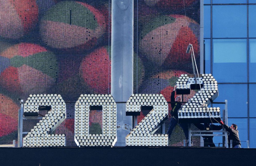PHOTO: Workers add the number 2 to the numerals above Times Square ahead of New Year's Eve celebrations in New York City, Dec. 26, 2021.