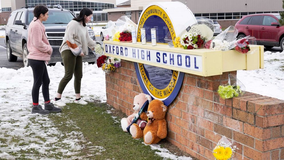 PHOTO: Students leave flowers at the sign of Oxford High School where memorial items are being placed in Oxford, Mich., Dec. 1, 2021. 