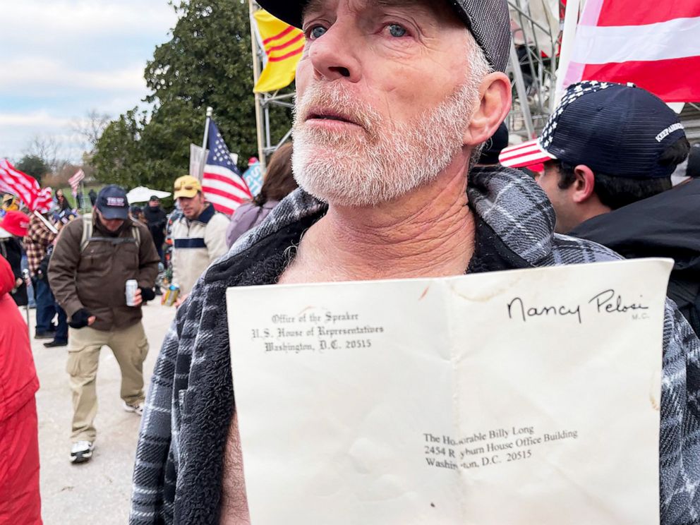 PHOTO: Richard "Bigo" Barnett, 60, from Gravette, Ark., shows off the envelope he took from House Speaker Nancy Pelosi's office at the Capitol in Washington, Jan. 6, 2021. 