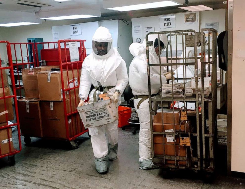 PHOTO: US Defense Department personnel, wearing protective suits, screen mail as it arrives at the Pentagon in Washington, Oct. 2, 2018.