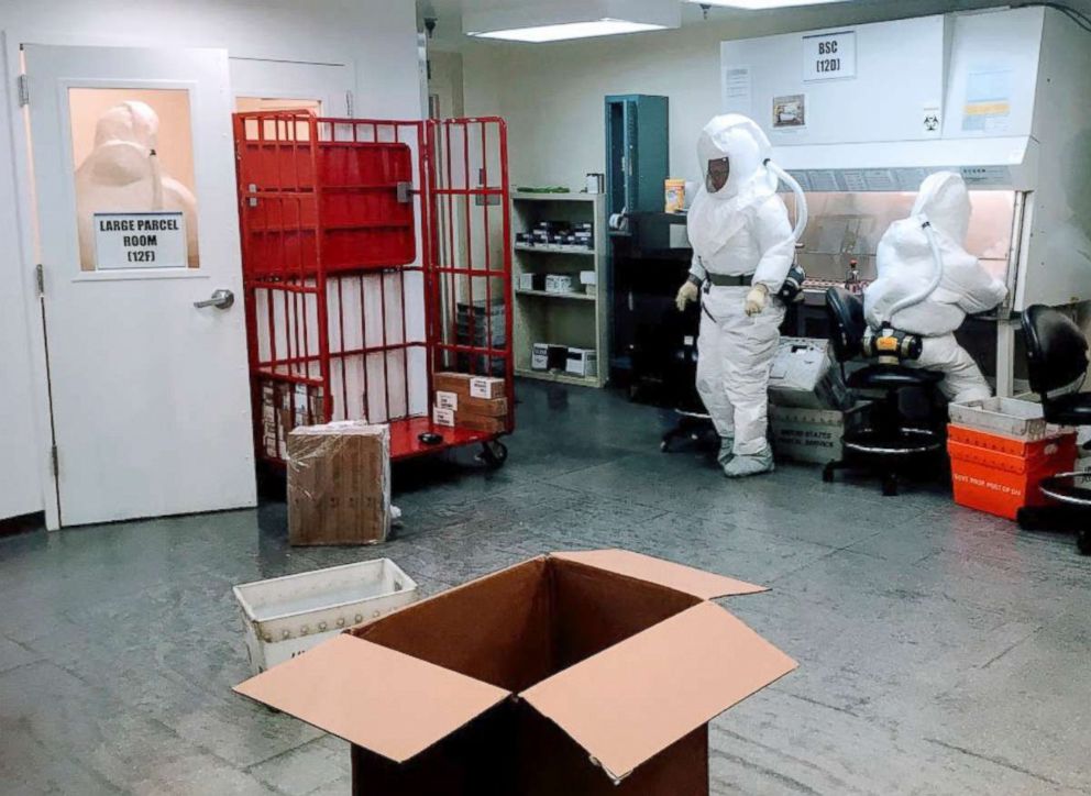 PHOTO: US Defense Department personnel, wearing protective suits, screen mail as it arrives at the Pentagon in Washington, Oct. 2, 2018.