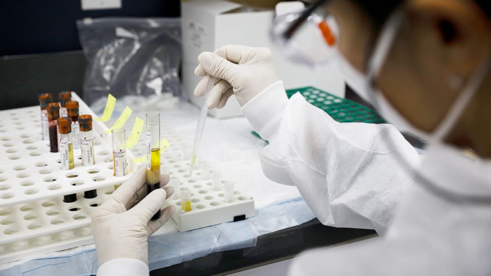 PHOTO: A health worker wearing a protective mask works in a lab during clinical trials for a Covid-19 vaccine at Research Centers of America in Hollywood, Fla., Sept. 9, 2020. 