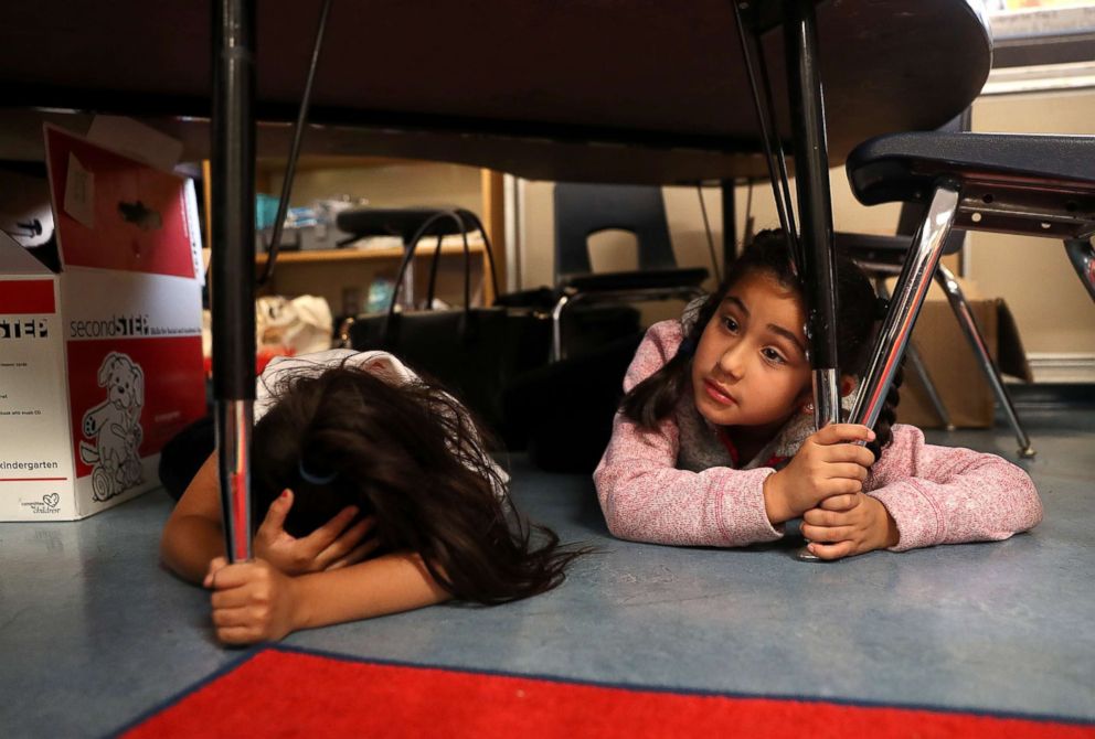 PHOTO: Students at Bryant Elementary School take cover under their desks during an earthquake drill as part of the Great ShakeOut event, Oct. 18, 2018, in San Francisco.