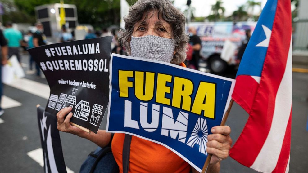 PHOTO: People march along Las Americas Highway to protest the LUMA Energy company in San Juan, Puerto Rico, Oct. 15, 2021. 