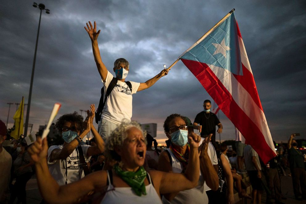 PHOTO: People march along Las Americas Highway to protest the LUMA Energy company in San Juan, Puerto Rico, Oct. 15, 2021. 