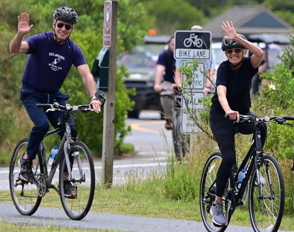 PHOTO: President Joe Biden and First Lady Jill Biden ride bicycles in Cape Henlopen State Park in Lewes, Del., JUne 3, 2021.