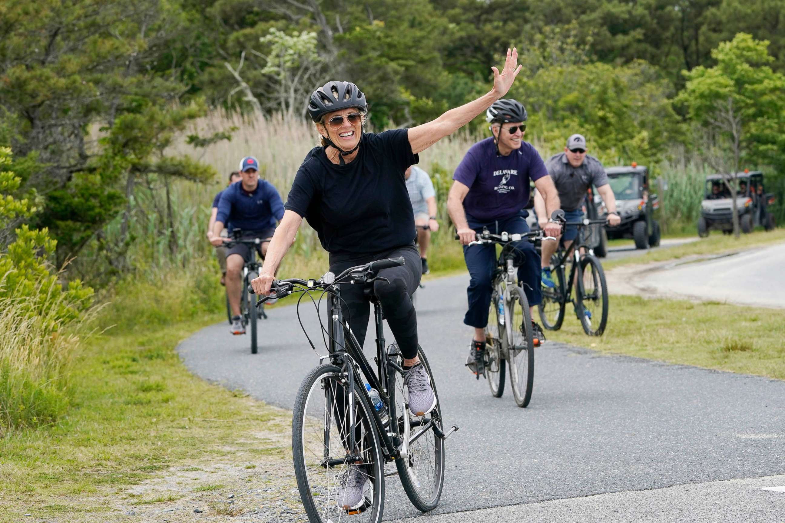 PHOTO: First lady Jill Biden waves as she rides her bike with President Joe Biden in Rehoboth Beach, Del., June 3, 2021.