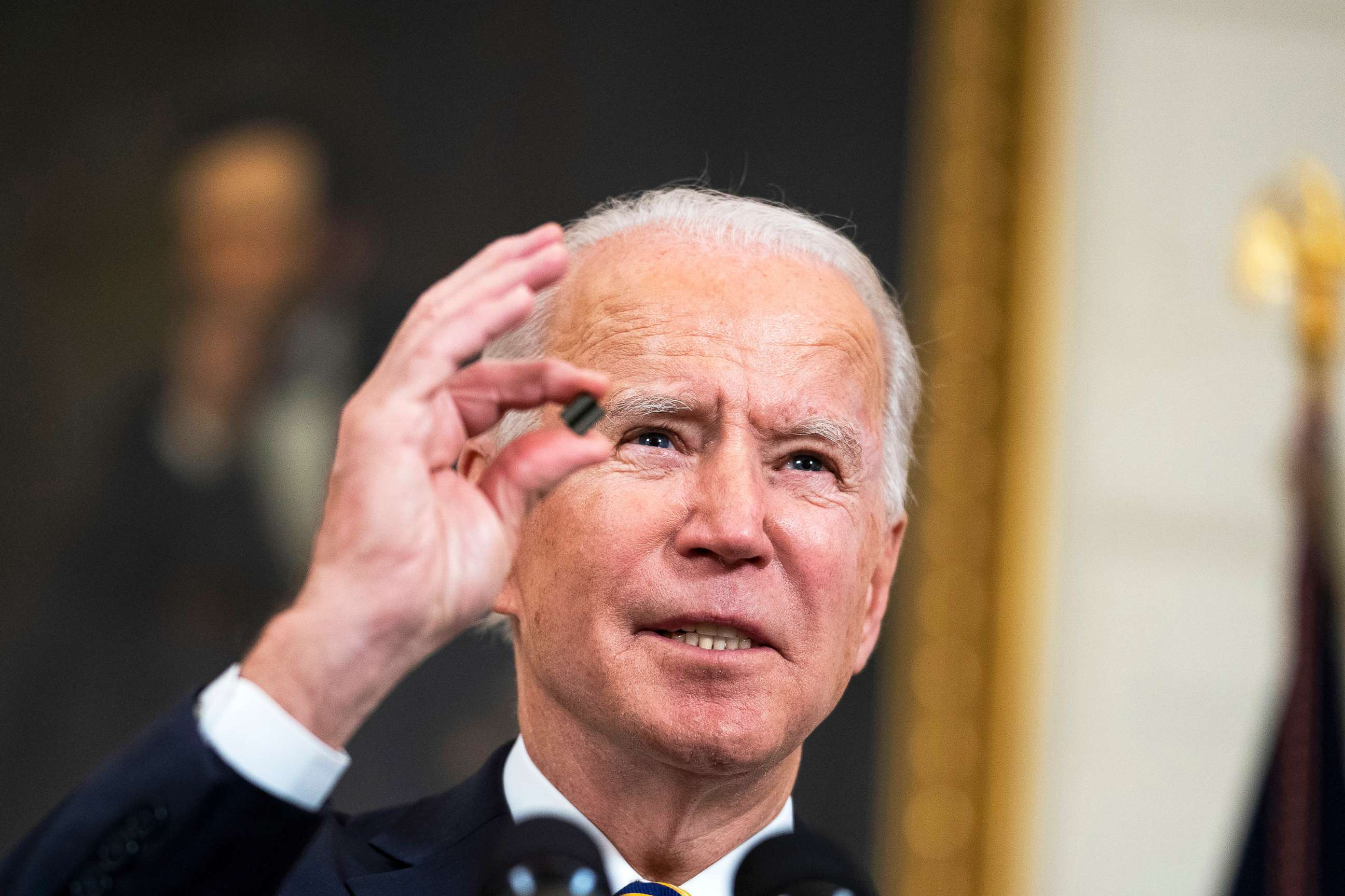 PHOTO: President Joe Biden holds a semiconductor during his remarks before signing an Executive Order on the economy in the State Dining Room of the White House, Feb. 24, 2021. 
