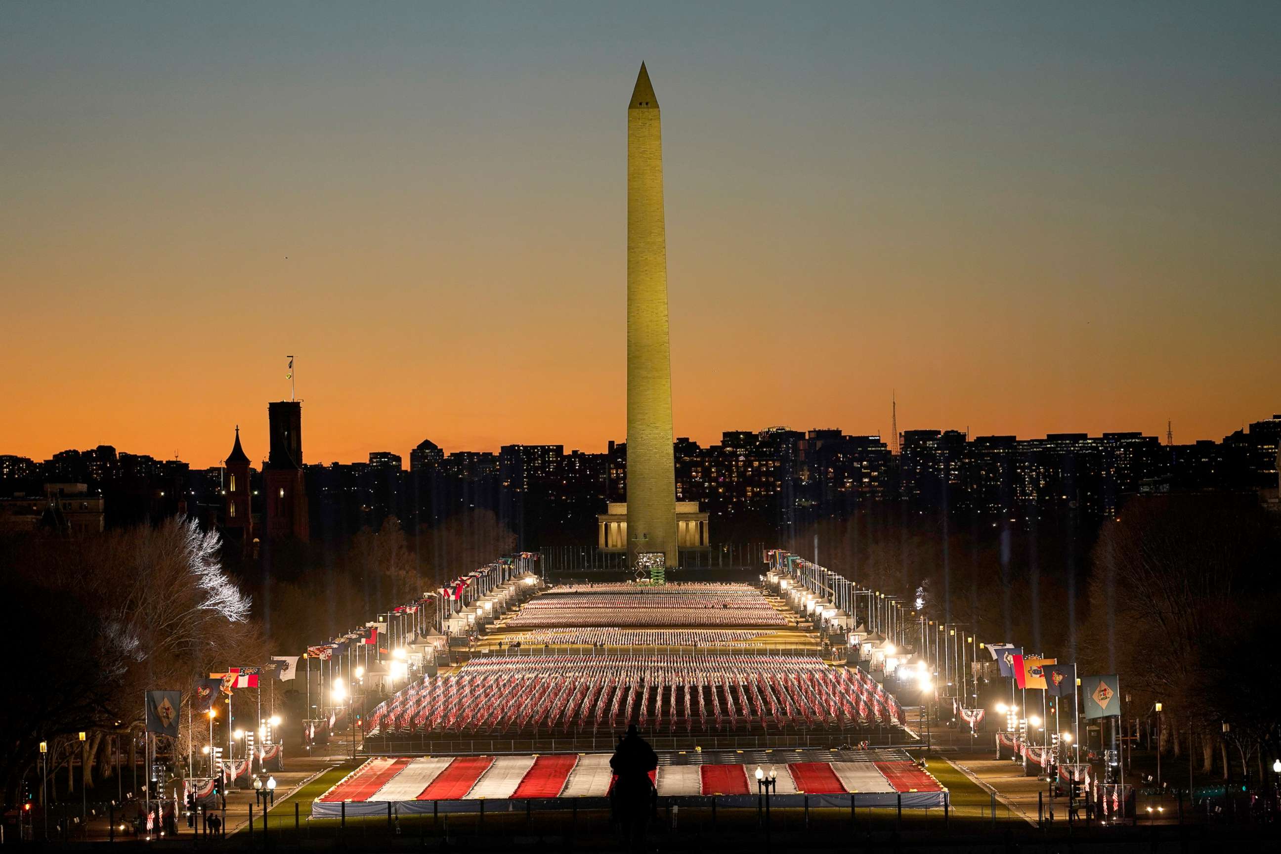 PHOTO: A field of flags is spread across the National Mall, with the Washington Monument in the background in Washington, Jan. 19, 2021.   