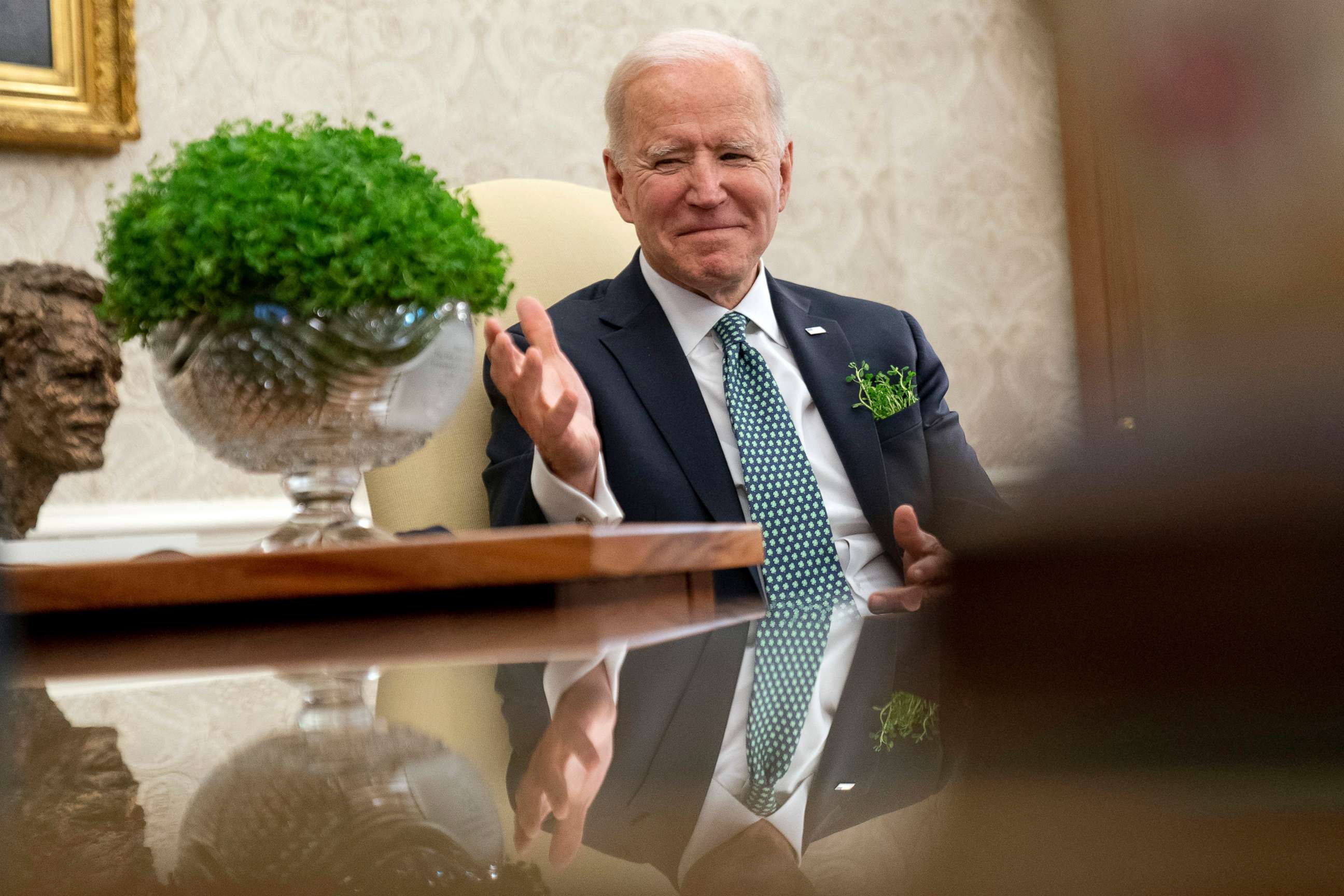 PHOTO: President Joe Biden sits next to a bowl of Irish shamrocks as he has a virtual meeting with Ireland's Prime Minister Micheal Martin on St. Patrick's Day, in the Oval Office of the White House, March 17, 2021.