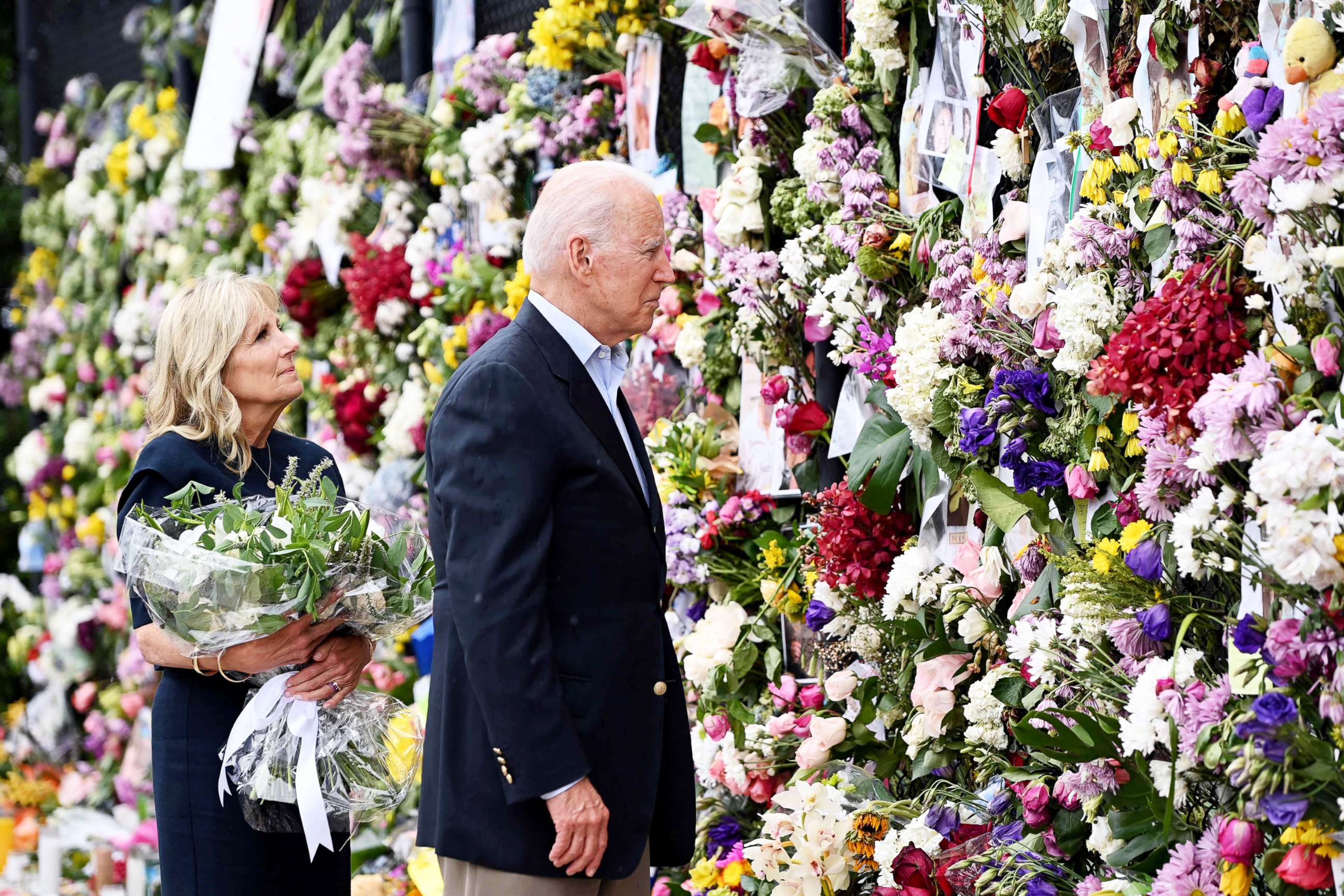 PHOTO: President Joe Biden and First Lady Jill Biden visit a photo wall, the 'Surfside Wall of Hope & Memorial', near the partially collapsed 12-story Champlain Towers South condo building in Surfside, Fla.,  July 1, 2021. 
