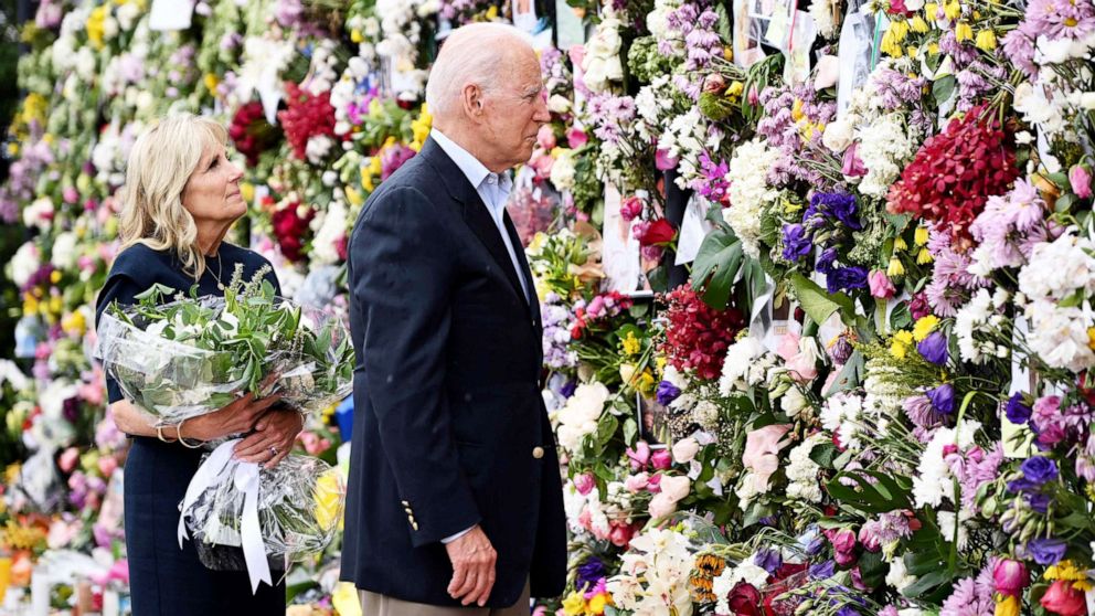 PHOTO: President Joe Biden and First Lady Jill Biden visit a photo wall, the 'Surfside Wall of Hope & Memorial', near the partially collapsed 12-story Champlain Towers South condo building in Surfside, Fla.,  July 1, 2021. 