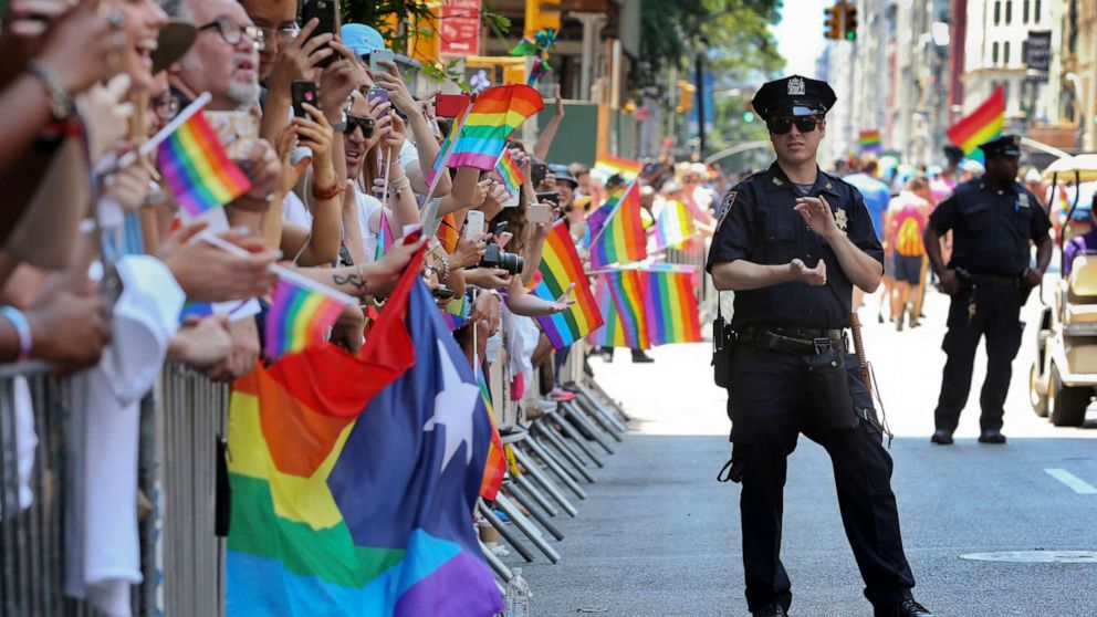 PHOTO: A police officer applauds as parade-goers celebrate during the New York City Pride Parade, in New York, June 26, 2016.