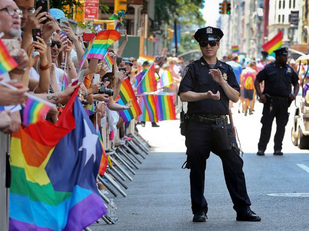 PHOTO: A police officer applauds as parade-goers celebrate during the New York City Pride Parade, in New York, June 26, 2016.